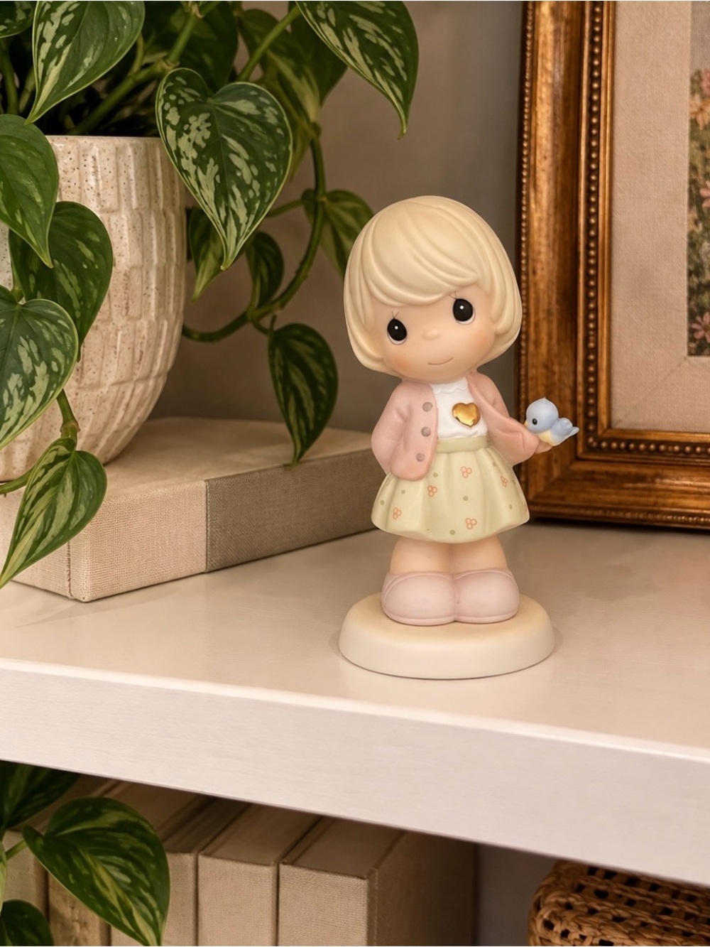 Precious Moments Blonde Girl Figurine in Pastel Pink, Cream, and Blue